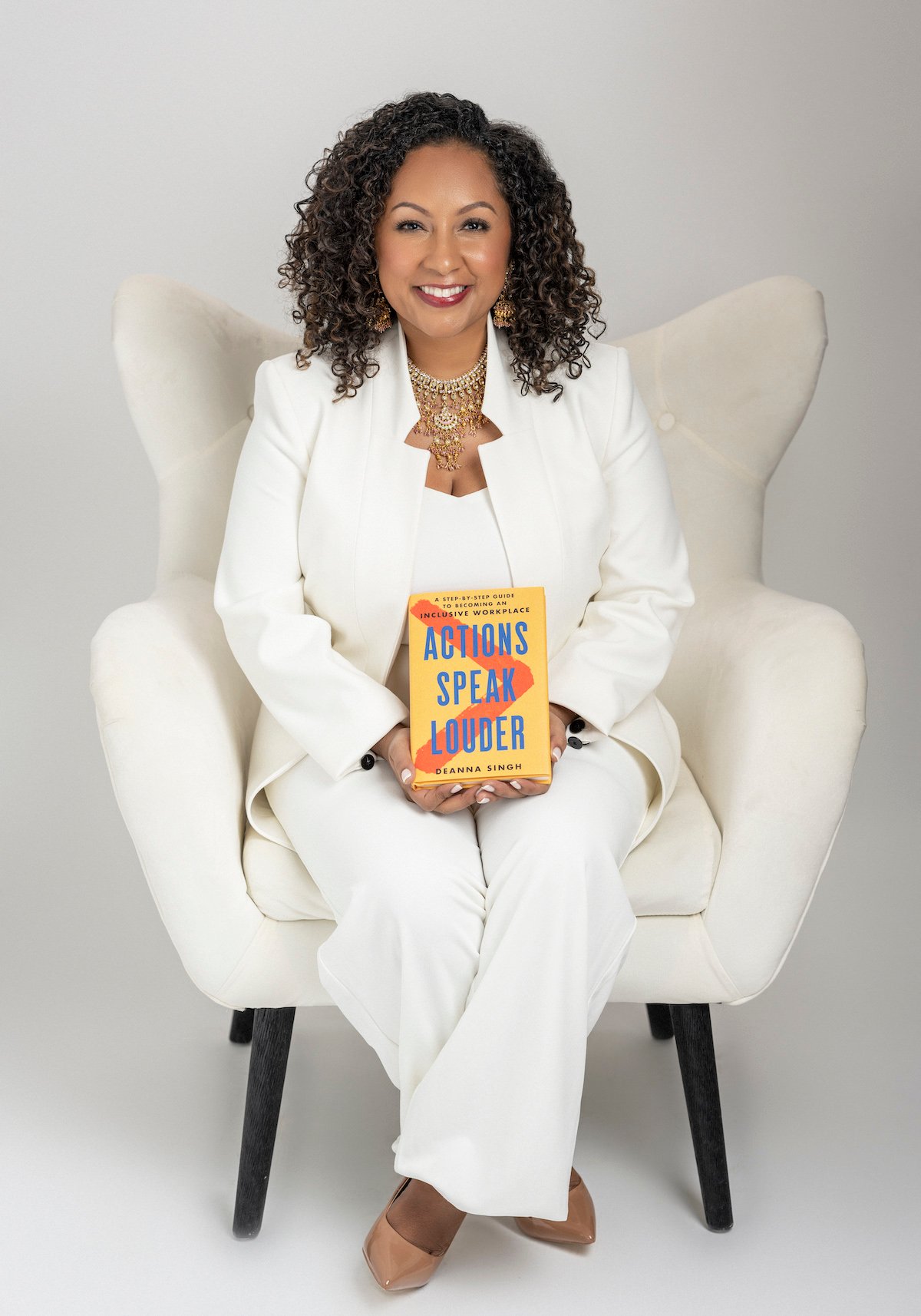 Deanna holding Actions Speak Louder book